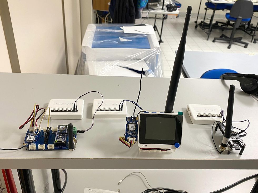 Small Language Models Power Life-Saving Small AI Two development boards and an IoT development platform running simultaneously on a lab table.